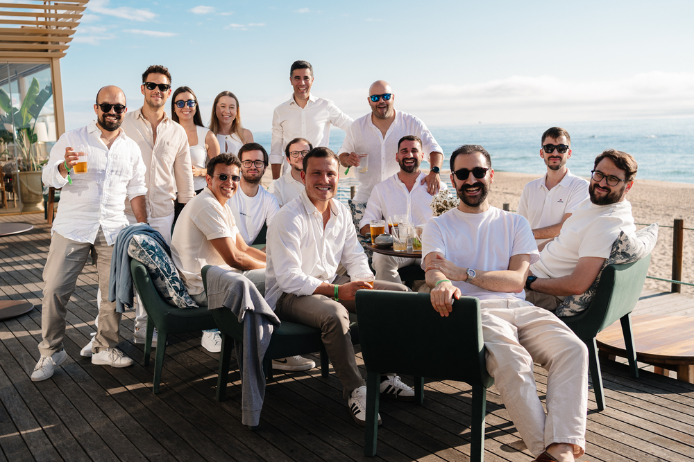 The xelerate.tech team posing together on a beach terrace
